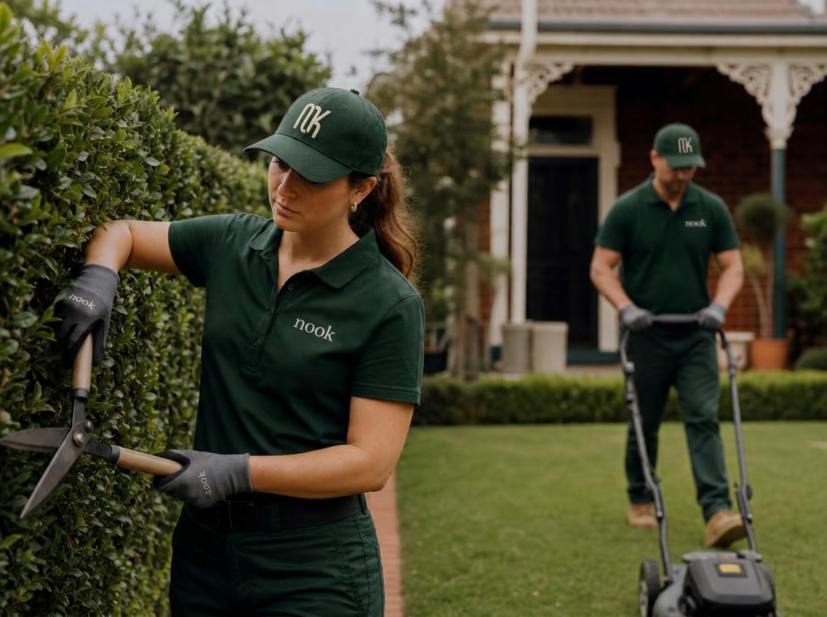 Gardener maintaining neat hedges and clearing green waste at a Melbourne property